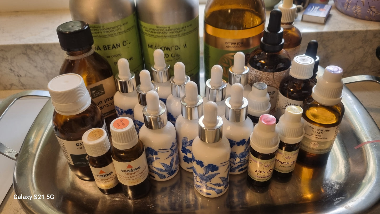 Collection of various bottles and droppers on a metal tray. Hair Serum