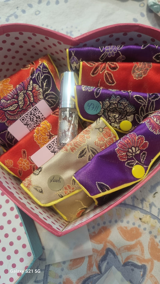Colorful fabric items in a decorative box on a patterned surface