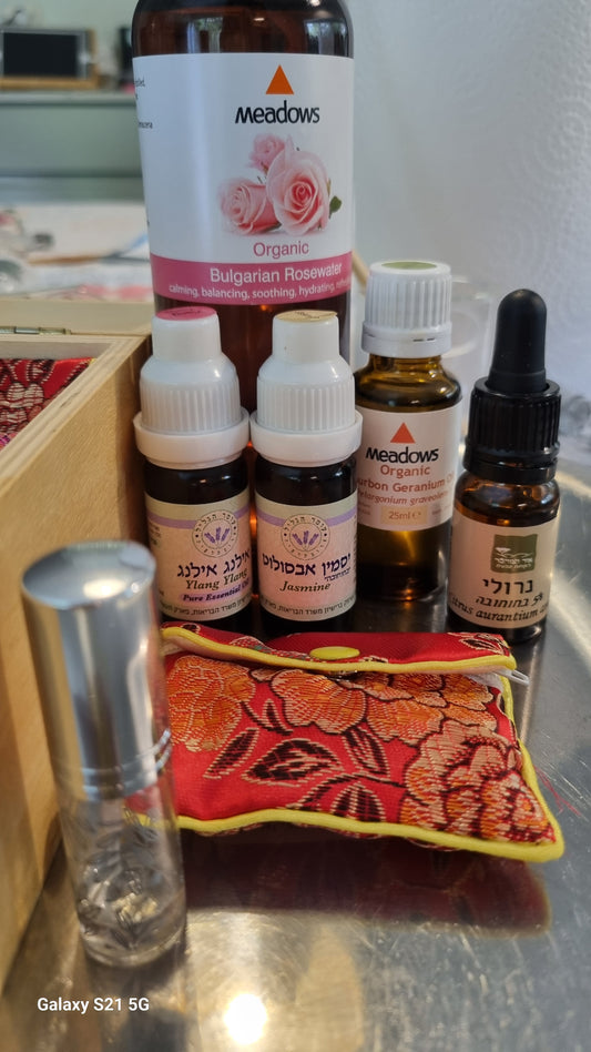 Collection of small bottles and a decorative pillow on a surface