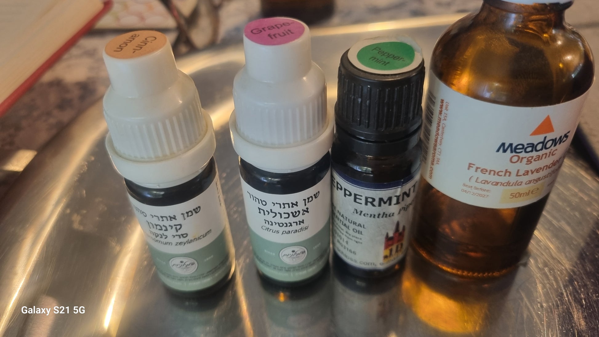 Collection of various bottles on a metallic surface