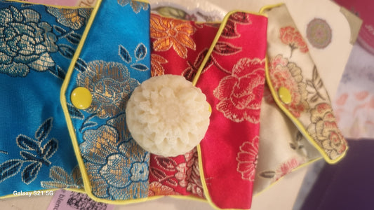 Decorative brooches with floral patterns on a colorful fabric background