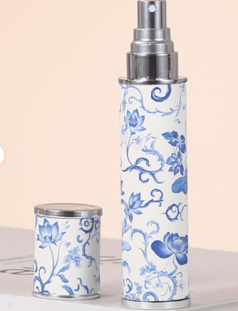 Two cylindrical containers with blue floral patterns on a beige background