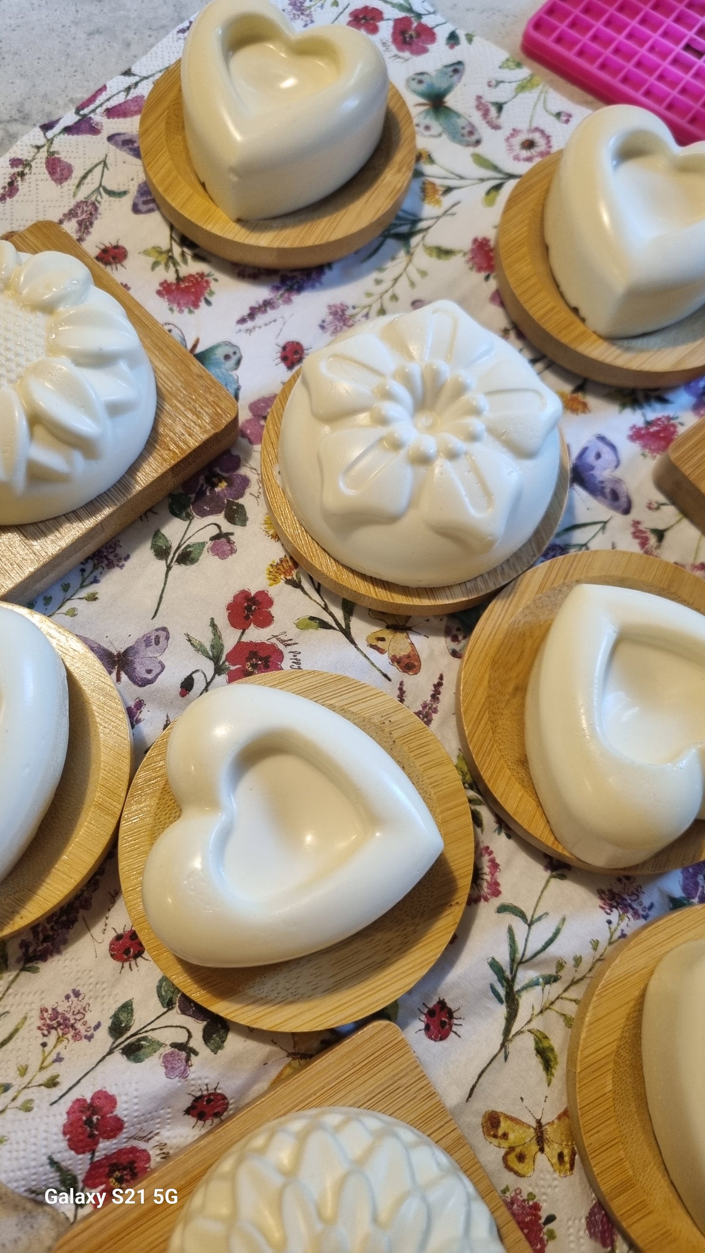 Heart Shaped Soaps in wooden molds on a floral tablecloth